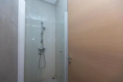 a bathroom with a shower with a glass door at Prestigia Luxe Suite by MERAT HOME in Rabat