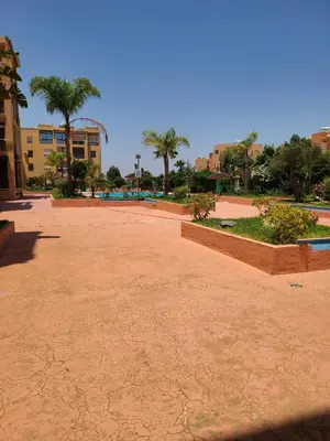 an empty park with palm trees in a city at Ricoflores palm benslimane in O Ben Slimane
