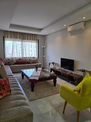 a living room with a couch and a coffee table at Charmant appartement à 10min de L' Aéroport Med V in Nouaceur