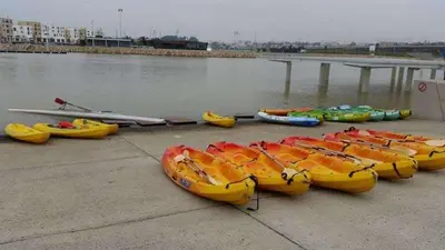 a group of kayaks lined up next to the water at Appartement neuf luxe OLM à Rabat in Rabat