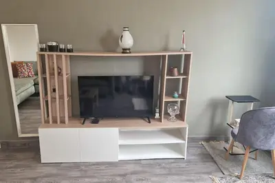 a living room with a tv on a white entertainment center at Welcome to km 0 of Casablanca in Casablanca