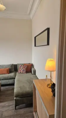 a living room with a couch and a table with a lamp at Welcome to km 0 of Casablanca in Casablanca