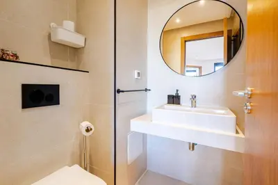 a bathroom with a sink and a mirror at Emplacement Chic Lumineux & Central Près du Consulat Américain 2 minutes de Twin Center Gauthier Casablanca in Casablanca