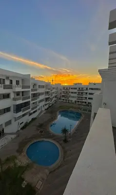 a view of an apartment complex with two swimming pools at Bel Appartement neuf à 7 min de la plage avec piscine privée in Mohammedia