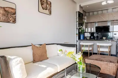 a living room with a couch and a glass table at Modern Ocean View Apartment in Casablanca