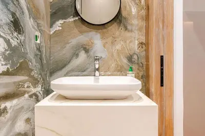 a bathroom with a white sink and a mirror at Modern Ocean View Apartment in Casablanca