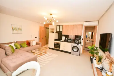 a living room with a couch and a kitchen at Studio 07 Maarif - High Speed Wi-Fi in Casablanca