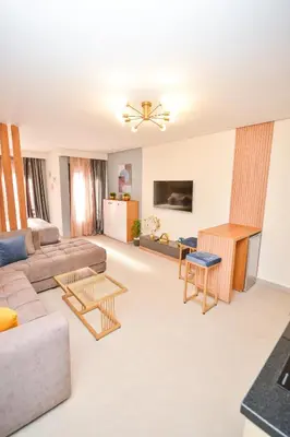 a living room with a couch and a table at Studio 08 Maarif - High Speed Wi-Fi in Casablanca