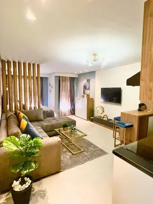 a living room with a couch and a table at Studio 08 Maarif - High Speed Wi-Fi in Casablanca