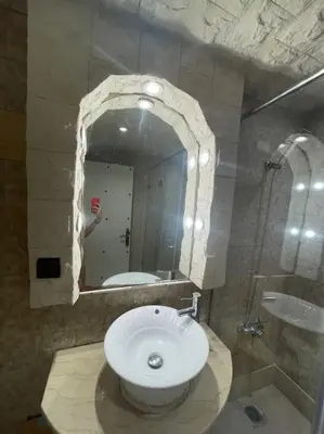 a bathroom with a sink and a mirror at Spacieux appartement corniche in Casablanca