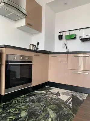 a kitchen with a rug on the floor at The Atlantica Ocean view apartment in Dar Bouazza
