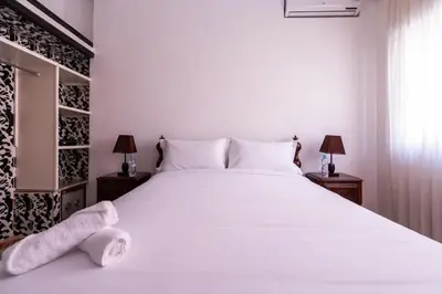 a bedroom with a large white bed with towels on it at Appartement Cosy et Confortable in Casablanca