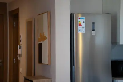 a kitchen with a stainless steel refrigerator in a room at Gauthier Luxe , 1BR Apart- Comfort & Style in Casa in Casablanca