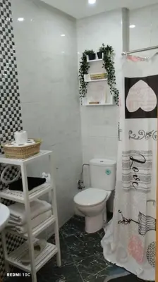 a bathroom with a toilet and a shower curtain at Appartement avec terrasse en plein centre de ville in Casablanca