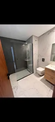 a bathroom with a glass shower and a toilet at Cosy studio avec grande terasse et parking CFC in Casablanca