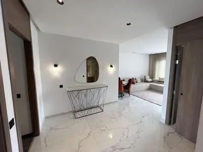 a living room with a mirror and a couch at Appartement vaste et lumineux, Oasis in Casablanca