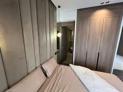 a bed in a room with a wall at Appartement vaste et lumineux, Oasis in Casablanca
