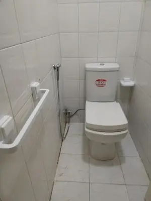 a white bathroom with a toilet and a bath tub at Sense housse in Rabat