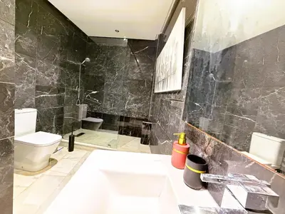 a bathroom with a sink and a toilet and a shower at Cosy sunny central - 2 BDR near train and tram in Casablanca