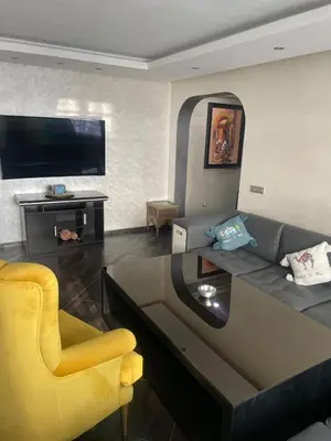a living room with a couch and a tv at Casablanca Bourgogne in Casablanca