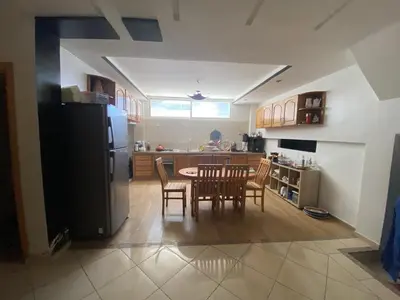 a kitchen with a table and chairs and a refrigerator at Duplex in Casablanca
