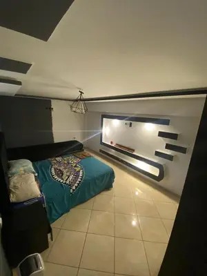 a bedroom with a bed and a window in it at Duplex in Casablanca