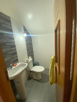 a small bathroom with a toilet and a sink at Duplex in Casablanca