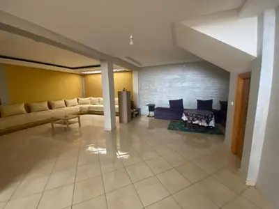 a large living room with couches and a fireplace at Duplex in Casablanca
