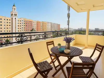 a balcony with a table and chairs on a balcony at Cosy sunny 2BR - central near train and tram in Casablanca