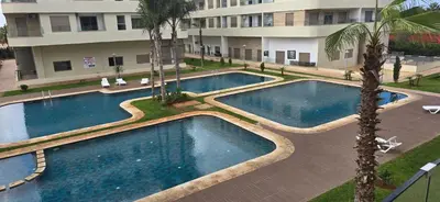 an overhead view of two swimming pools in a building at appartement haut standing avec piscine a cote de la plage et du golf a bouznika in Bouznika