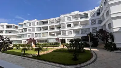 a large white apartment building with a courtyard at Salah in Bouznika