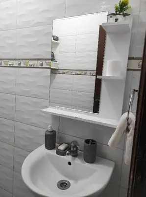 a bathroom with a white sink and a mirror at appartement 3 min à Casa nearshore & Université Hassan 2 in Casablanca