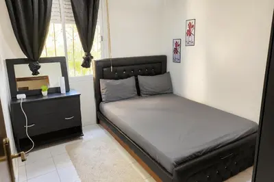 a small bedroom with a bed and a window at appartement 3 min à Casa nearshore & Université Hassan 2 in Casablanca