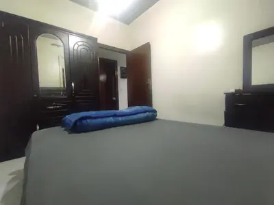 a bedroom with a bed with a blue pillow on it at appartement 3 min à Casa nearshore & Université Hassan 2 in Casablanca
