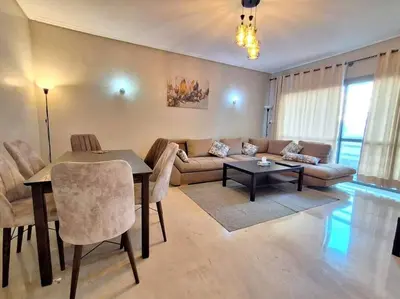 a living room with a couch and a table at Elegant 2-Bedroom Apartment in Vibrant Maarif in Casablanca