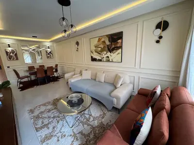 a living room with a couch and a table at Luxueux Appartement avec Piscine et Terrasse in Bouznika