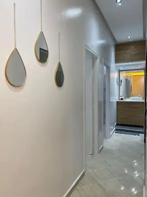 a hallway with two mirrors on a wall in a room at Naj'Appartement de charme in Temara