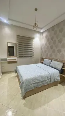 a bedroom with a bed and a television in it at Naj'Appartement de charme in Temara