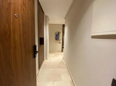 a hallway of a room with a door and a hallway at Findy Maarif avec jardin privé in Maarif