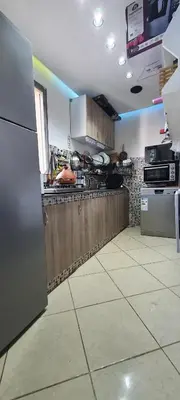 a kitchen with a stainless steel refrigerator and appliances at Settat room Homy in Settat