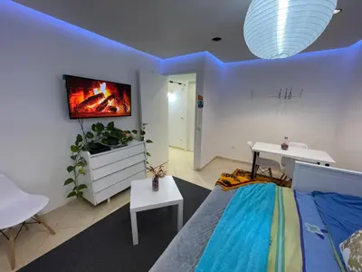 a room with a bed and a tv on a wall at Settat room Homy in Settat