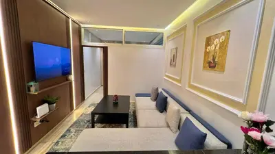 a living room with a couch and a tv at Stylish 2BR Appartement Central - 5 min Casa port in Casablanca