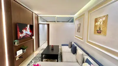 a living room with a couch and a table at Stylish 2BR Appartement Central - 5 min Casa port in Casablanca
