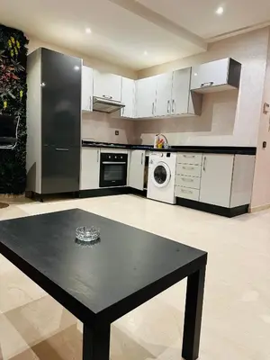 a kitchen with a black table and a black refrigerator at STUDIO CASABLANCA BEsT STAY 1 in Casablanca