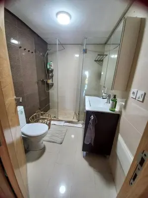 a bathroom with a shower and a toilet and a sink at Appart à Ola Blanca 2 près de Sidi Rahal in Bir Jedíd Saint-Hubert