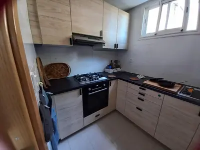 a small kitchen with a stove and a sink at Appart à Ola Blanca 2 près de Sidi Rahal in Bir Jedíd Saint-Hubert