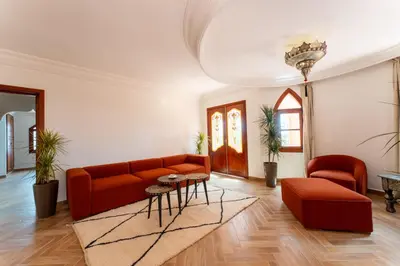a living room with a couch and a table at Château Loriana in Bouznika