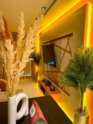 a living room with a tv and some plants at Cosy in Casablanca