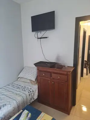 a bedroom with a dresser and a flat screen tv at Moonskhirat in Skhirat