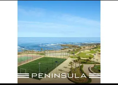 a view of the ocean and a park next to the beach at Appartement pied sur mer- resid férmé- pscine in Tamaris